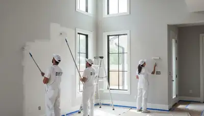 Professional interior house painters finishing living room walls in Billings, MT